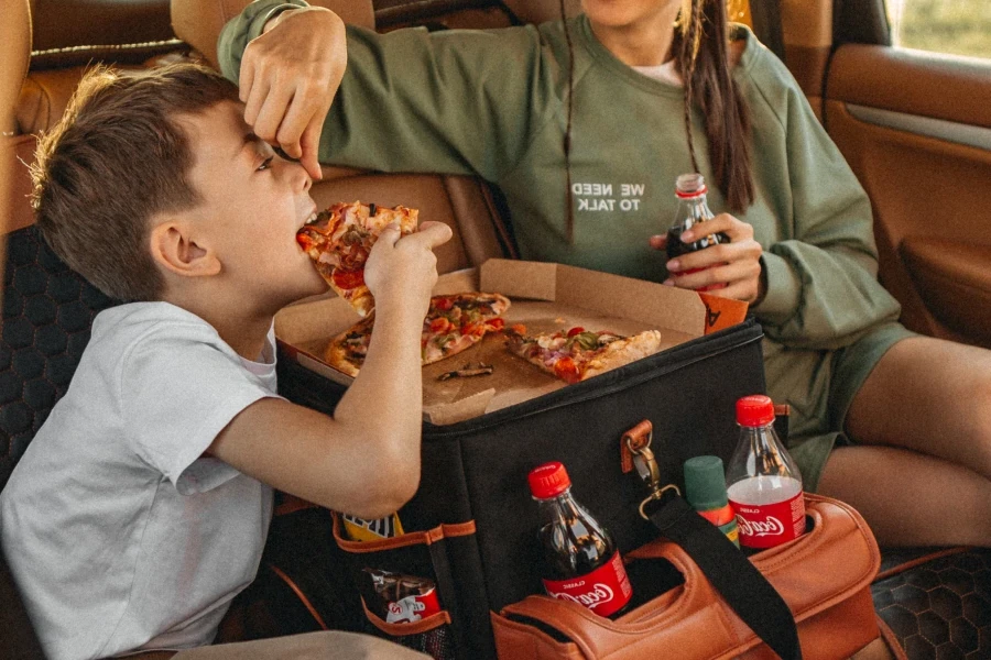 child eating pizza on organizer lid